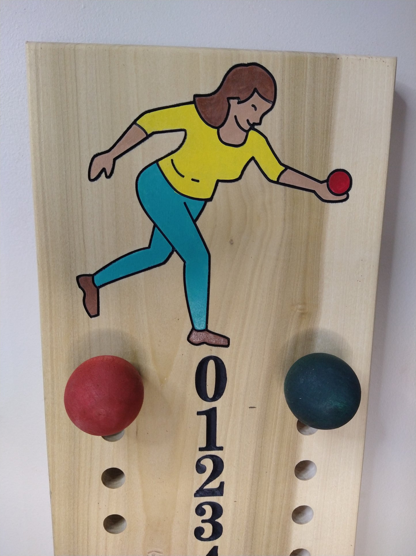 Close-up of female image on poplar bocce scoreboard