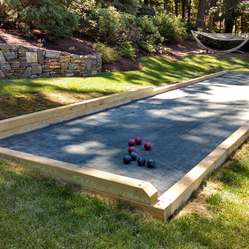 Har-Tru bocce court with wood edging and green and red bocce balls