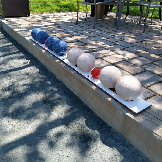 Marine grade bocce ball holders mounted on wood edging