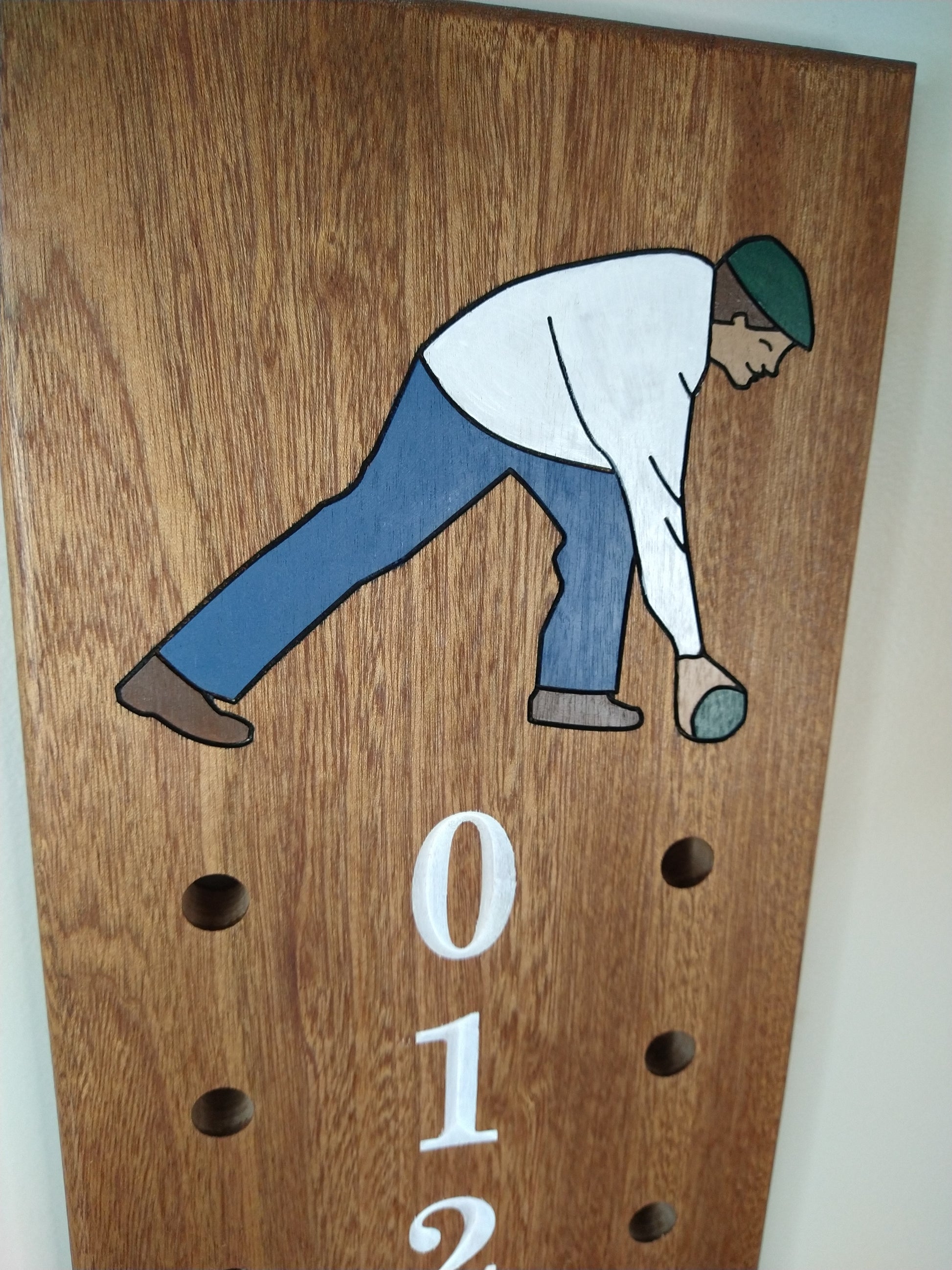 Close-up gentleman image on mahogany bocce scoreboard