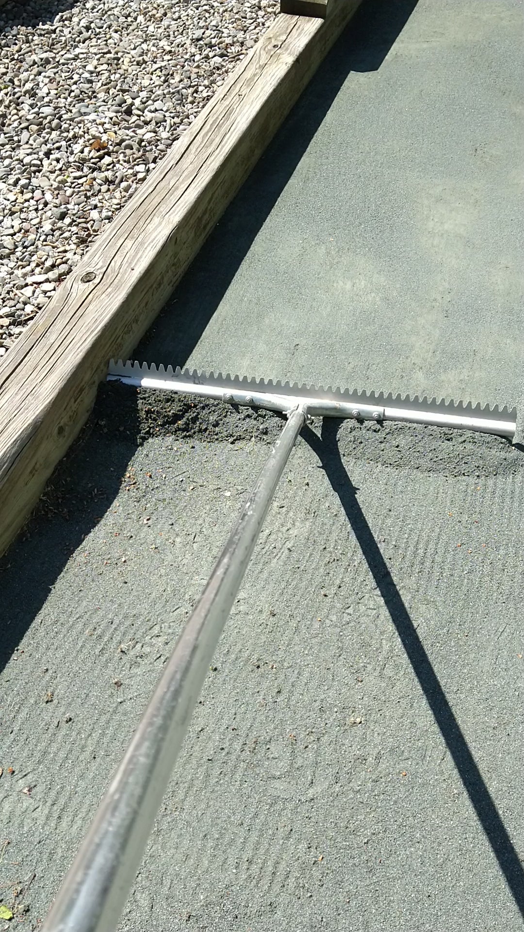 Bocce rake cleaning and leveling a bocce court