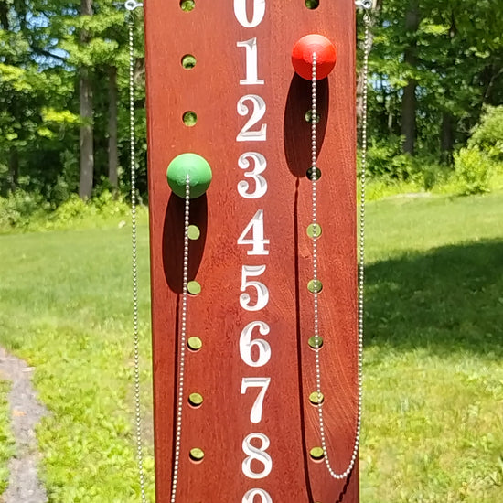 Mahogany bocce scoreboard numbered 0-12 with scoring pegs and chain