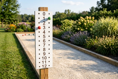 White scoreboard with brown numbers beside a bocce court