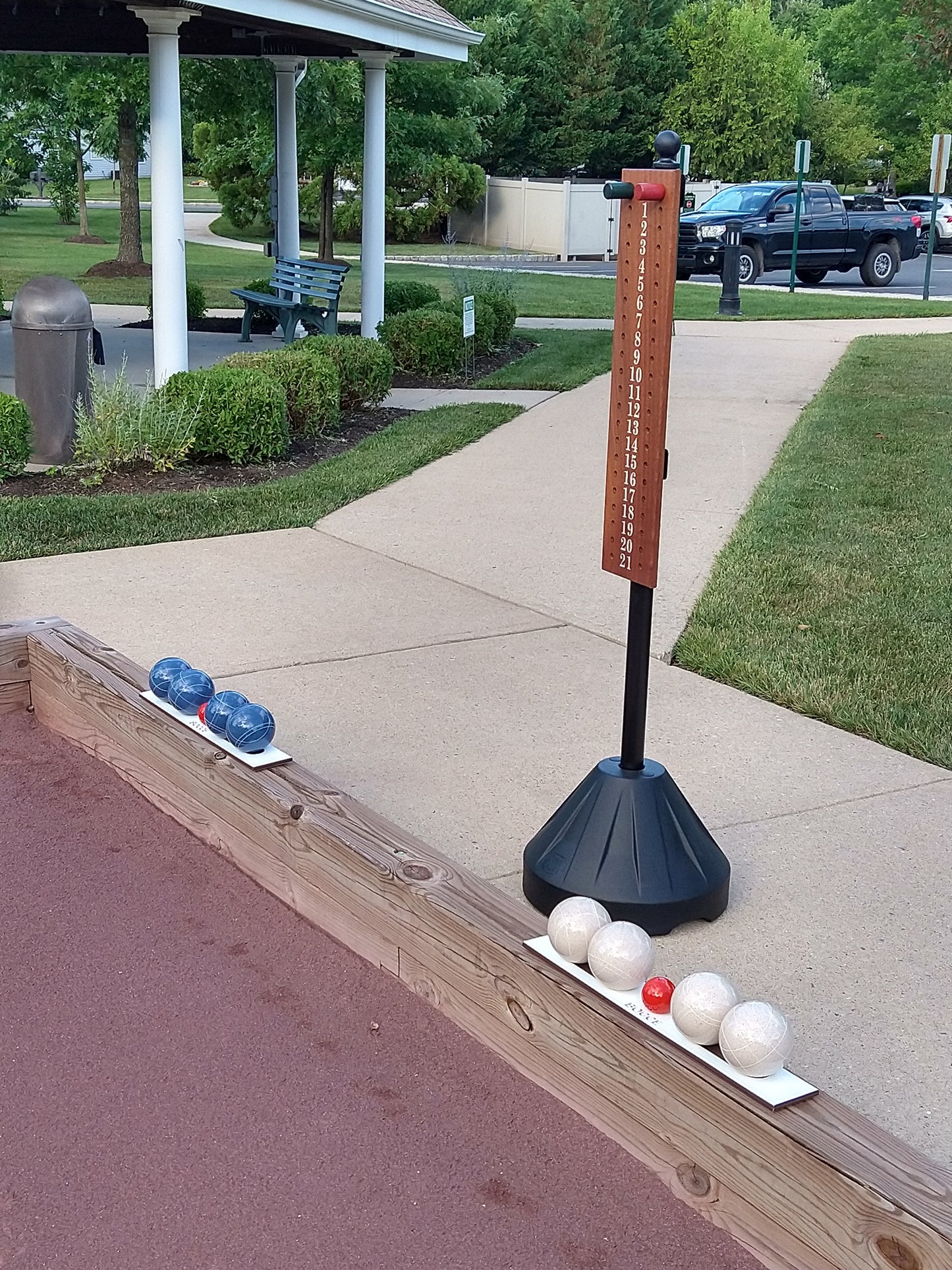 Bocce ball racks on court edging with scoreboard and stand